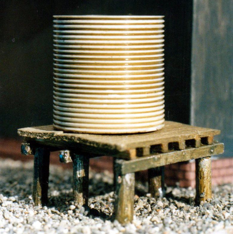 Corrugated iron water tank on base